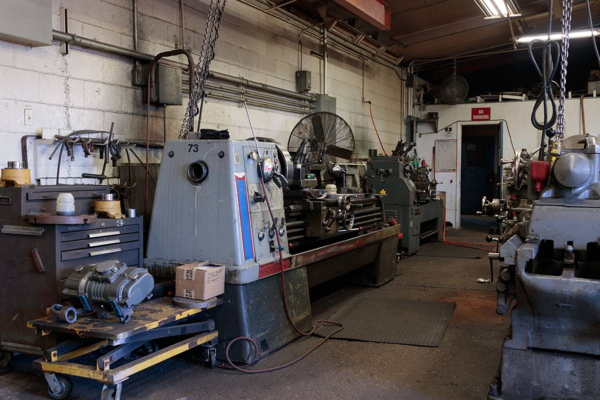 Interior of a workshop featuring various industrial machines and equipment for metalwork.