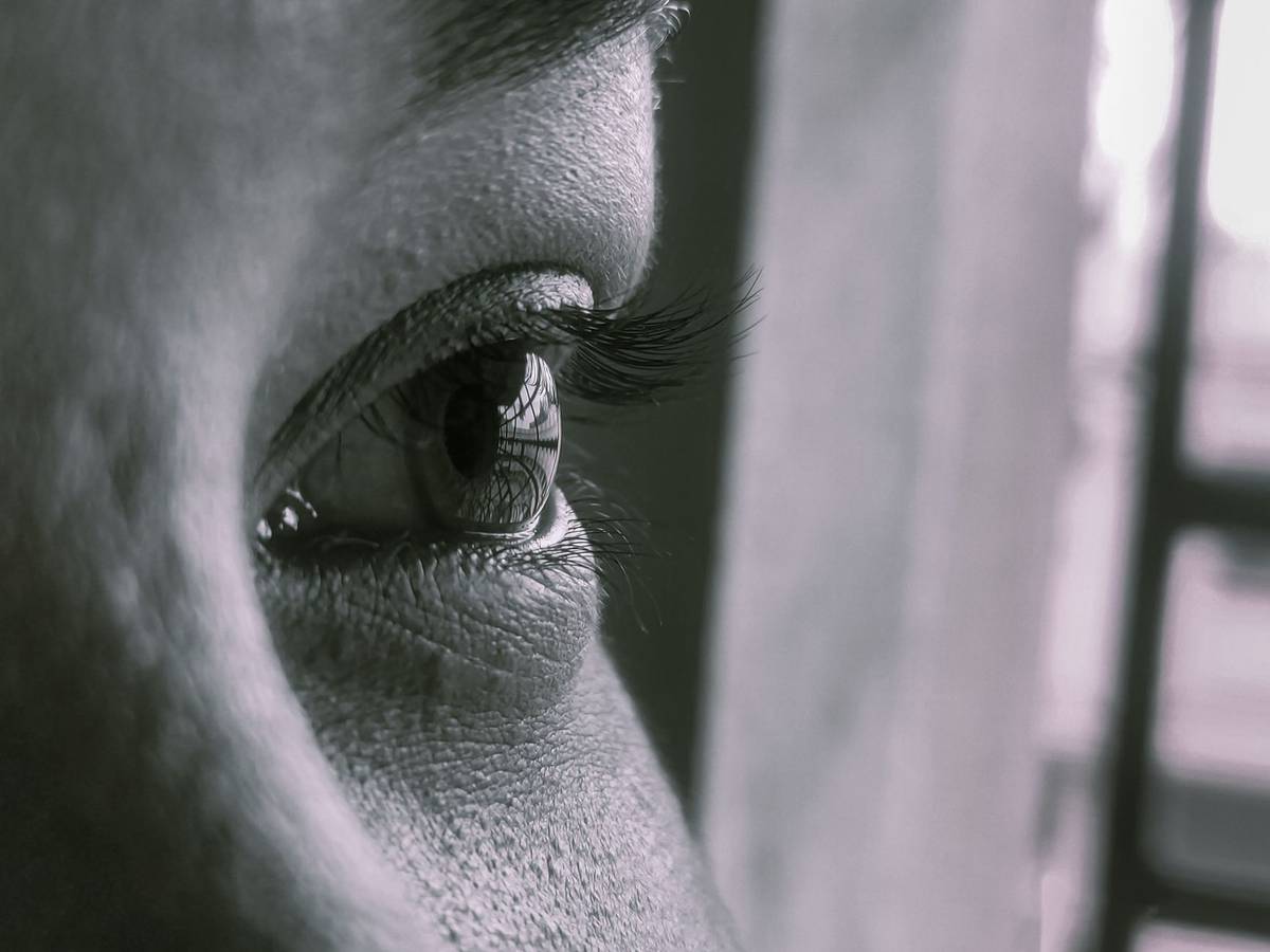 Detailed close-up of a human eye showcasing eyelashes and skin texture.