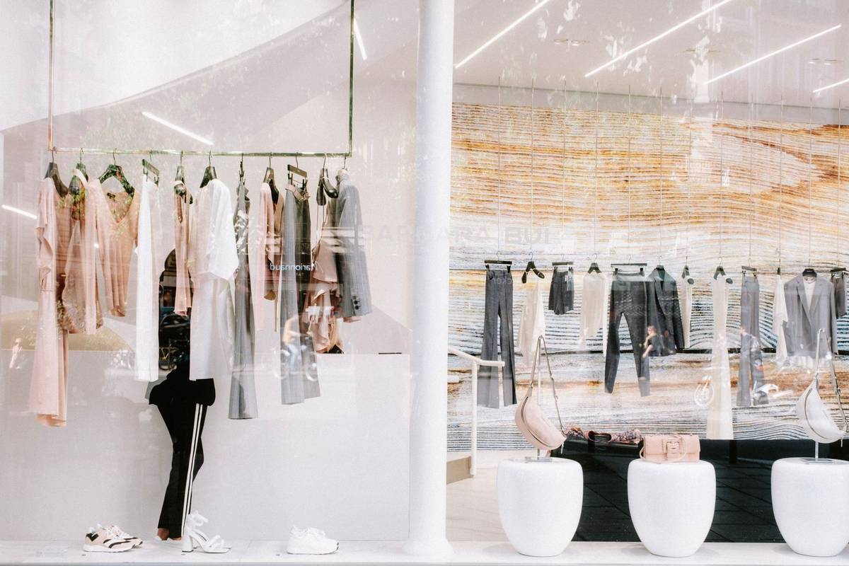 Clothes hanging on clothing racks in a store