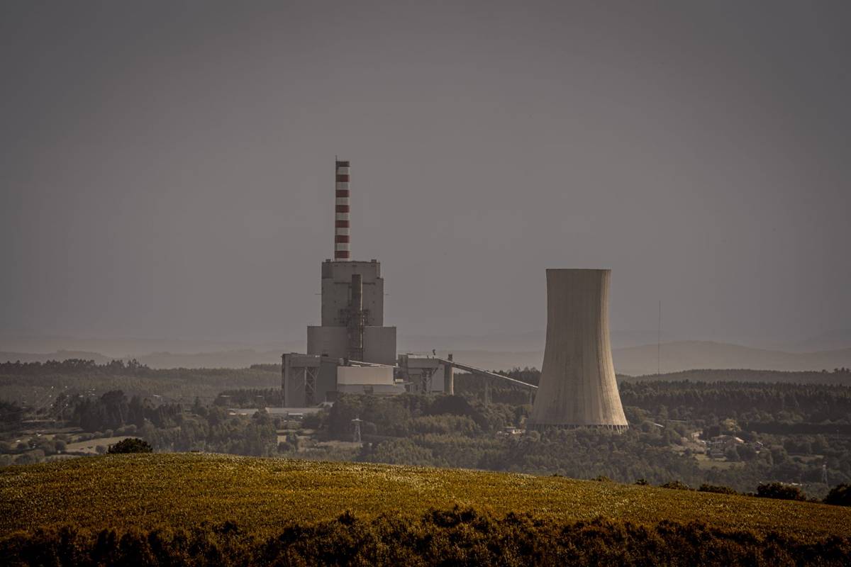 A power plant with cooling towers in a valley.