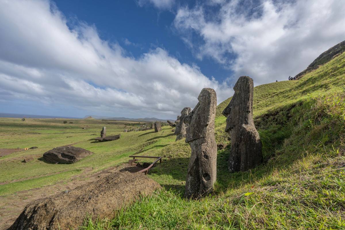 Moai statues on Easter Island under a blue sky.
